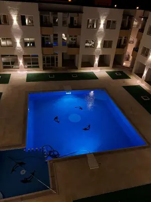 a large swimming pool in the middle of a building at Port Ghalib Apartments in Port Ghalib