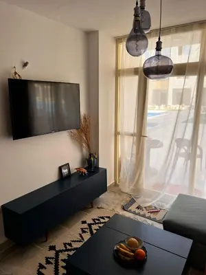 a living room with a flat screen tv on a wall at Port Ghalib Apartments in Port Ghalib