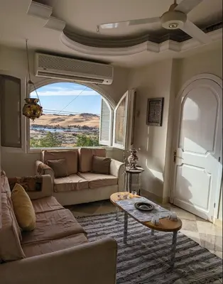 a living room with a couch and a table at Aswan Nile view Family apartment in Aswan