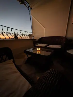 a room with two chairs and a table and a window at Aswan Nile view Family apartment in Aswan
