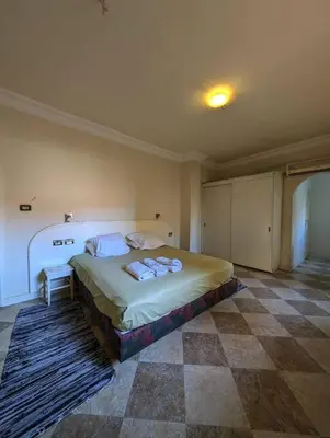 a bedroom with a bed with two pillows on it at Aswan Nile view Family apartment in Aswan
