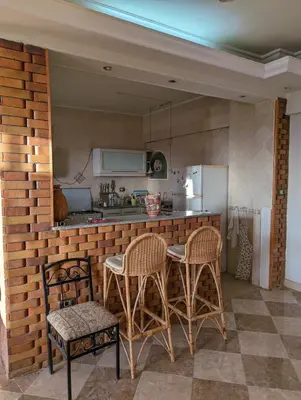 a kitchen with a table and chairs and a counter at Aswan Nile view Family apartment in Aswan