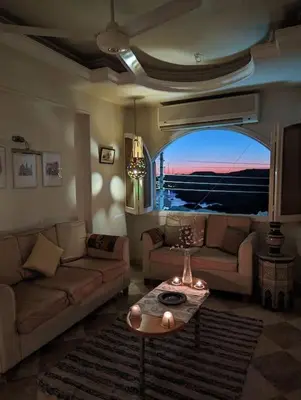 a living room with a couch and a table at Aswan Nile view Family apartment in Aswan
