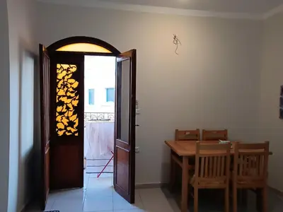 a dining room with a table and a door at HW.Appartment in Hurghada