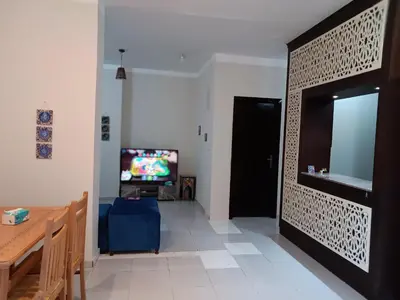 a living room with a television and a door at HW.Appartment in Hurghada
