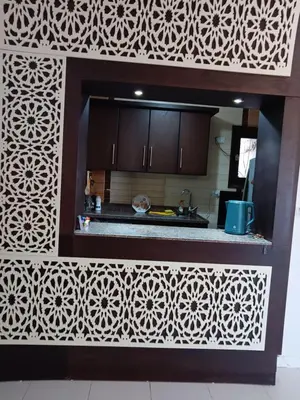 a kitchen with a white patterned wall in a kitchen at HW.Appartment in Hurghada