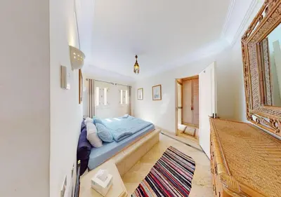 a bedroom with a bed in the corner of a room at Stylish Apartment 3 Brooms MB1at Marina Abu-Tig with Marina View in Hurghada