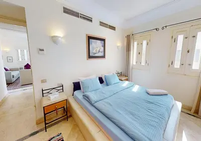 a bedroom with a large bed with blue sheets at Stylish Apartment 3 Brooms MB1at Marina Abu-Tig with Marina View in Hurghada