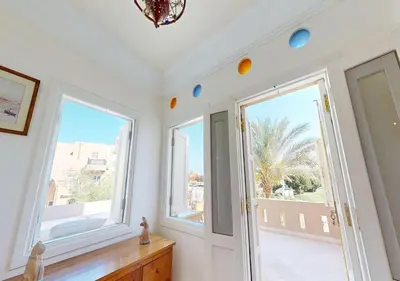 a room with white walls and large windows and a hallway at Stylish Apartment 3 Brooms MB1at Marina Abu-Tig with Marina View in Hurghada