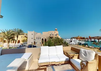 a balcony with white furniture and a view of the water at Stylish Apartment 3 Brooms MB1at Marina Abu-Tig with Marina View in Hurghada