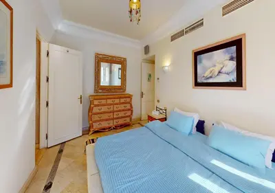 a bedroom with a blue bed and a mirror at Stylish Apartment 3 Brooms MB1at Marina Abu-Tig with Marina View in Hurghada