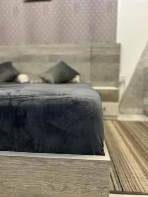 a bed with a black comforter on top of a table at Horizon on Mamsha 2 in Hurghada