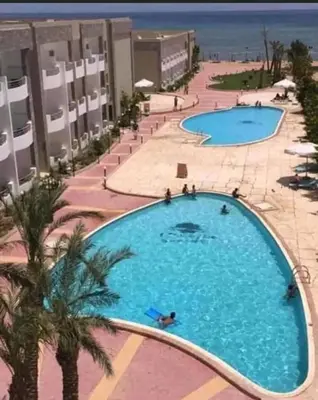 an overhead view of a large swimming pool at a resort at Apartment in Cecelia Resort in Hurghada