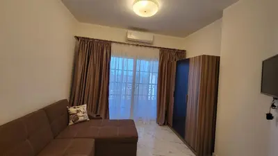 a living room with a couch and a large window at Juliana beach in Hurghada