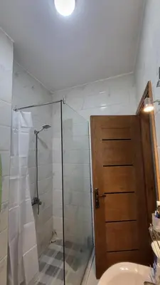 a bathroom with a shower and a glass door at Juliana beach in Hurghada