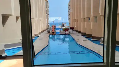 a view of a swimming pool from the window of a building at Juliana beach in Hurghada