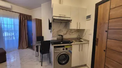 a kitchen with a sink and a washing machine at Juliana beach in Hurghada