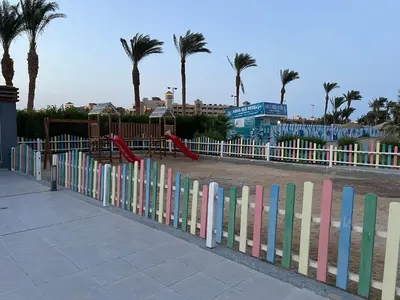 a colorful fence with a playground in a park at Luxury Seaview Apartment with Pool Scandic Resort Hurghada in Hurghada