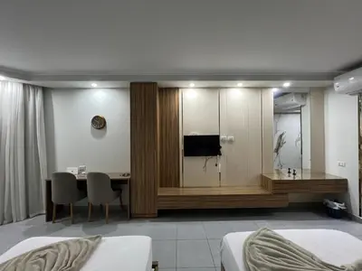 a hotel room with a desk and a bedroom at Luxury Seaview Apartment with Pool Scandic Resort Hurghada in Hurghada