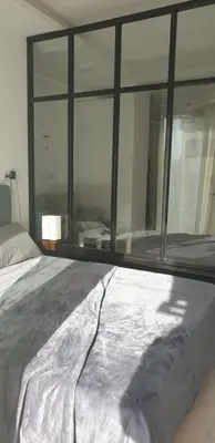 a bed in a bedroom with a large window at Studio In sky el Gandoul compound in Hurghada