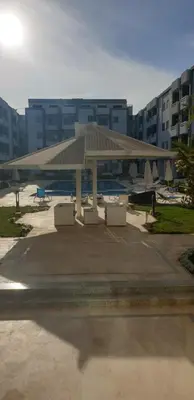 a pavilion in a parking lot in front of a building at Studio In sky el Gandoul compound in Hurghada