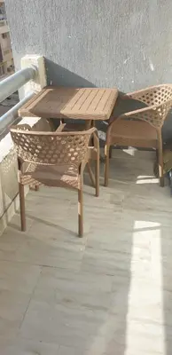 a wooden table and chairs sitting on a patio at Studio In sky el Gandoul compound in Hurghada