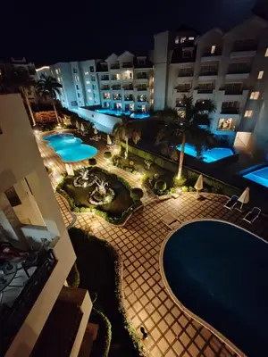 an overhead view of a swimming pool at night at Velký apartmán 50 m od pláže s přístupem zdarma- Sahl Hasheesh Hurghada resort Andalusie in Hurghada