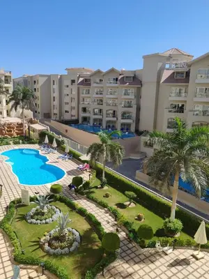 an aerial view of a resort with a pool and palm trees at Velký apartmán 50 m od pláže s přístupem zdarma- Sahl Hasheesh Hurghada resort Andalusie in Hurghada