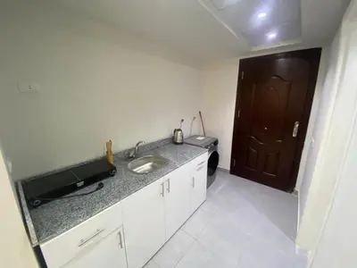 a small kitchen with a sink and a door at Scandic Resort in Hurghada