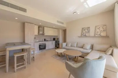 a living room with a couch and a table at Modern 1BR, Mangroovy, Gouna - 1BR, Pool, & Beach in Hurghada