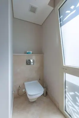 a bathroom with a white toilet in a room at Modern 1BR, Mangroovy, Gouna - 1BR, Pool, & Beach in Hurghada