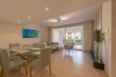 a dining room and living room with a table and chairs at Ground Floor 2BR Apt in Mangroovy, Pool & Beach in Hurghada