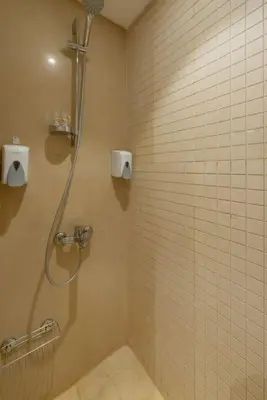 a bathroom with a shower with a glass door at Ground Floor 2BR Apt in Mangroovy, Pool & Beach in Hurghada