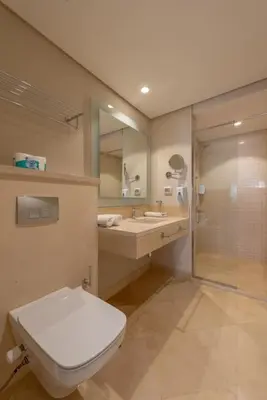 a bathroom with a toilet and a sink and a shower at Ground Floor 2BR Apt in Mangroovy, Pool & Beach in Hurghada