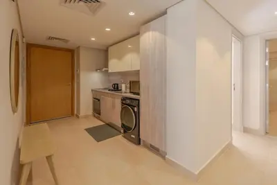 a kitchen with a washer and dryer in a room at Ground Floor 2BR Apt in Mangroovy, Pool & Beach in Hurghada