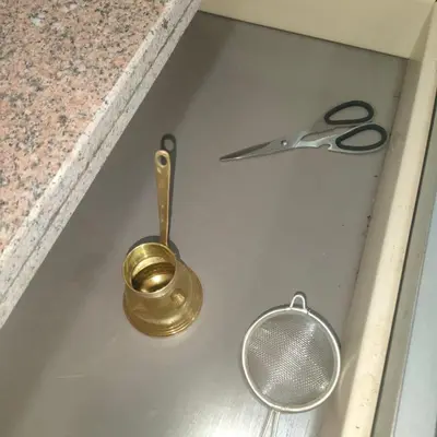 a pair of scissors sitting on a kitchen sink at Oscar luxury free WiFi 15 in Hurghada