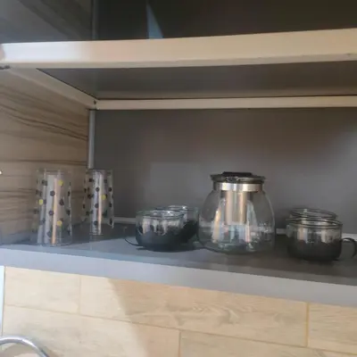a row of glass jars on a shelf in a kitchen at Oscar luxury free WiFi 15 in Hurghada