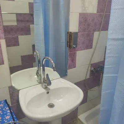 a white sink in a bathroom with a shower at Oscar luxury free WiFi 15 in Hurghada