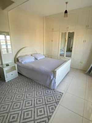 a bedroom with a large bed and a mirror at luxor Nile view duplex apartment in Luxor