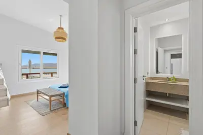 a white room with a sink and a bathroom at The Sandy Feet Sea Front in Hurghada