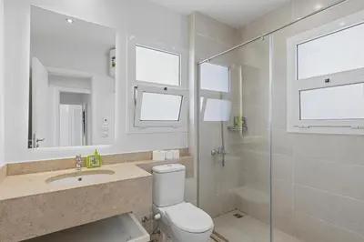 a bathroom with a toilet and a sink and a shower at The Sandy Feet Sea Front in Hurghada