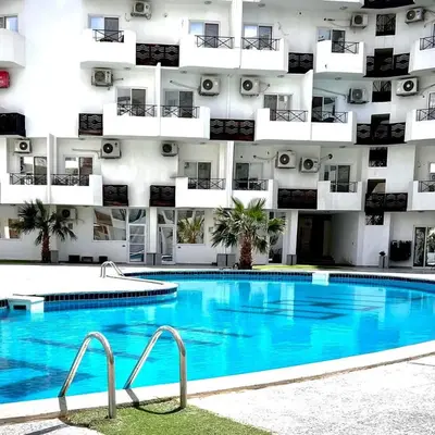 a swimming pool in front of a building at Tiba View in Hurghada