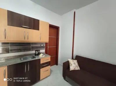a living room with a couch and a kitchen at Tiba View in Hurghada