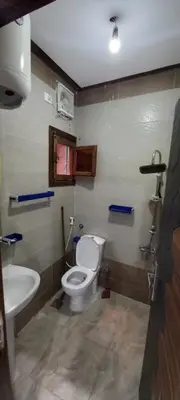 a bathroom with a toilet and a sink at Ikea flat 9 in Hurghada