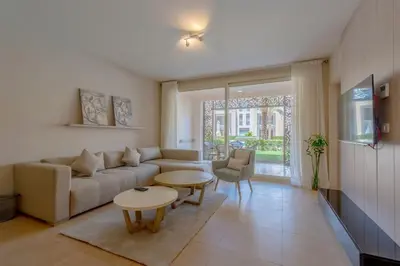 a living room with a couch and a table at Pool Front 2BR in Mangroovy - El Gouna, Beach Access in Hurghada