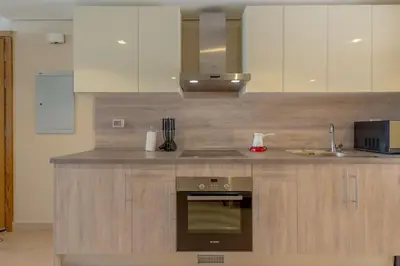 a kitchen with a sink and a stove top oven at Pool Front 2BR in Mangroovy - El Gouna, Beach Access in Hurghada