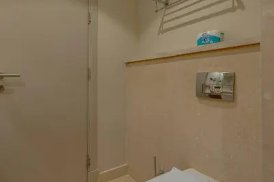 a bathroom with a towel dispenser on a wall at Pool Front 2BR in Mangroovy - El Gouna, Beach Access in Hurghada