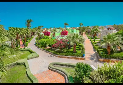 an aerial view of a park with palm trees and bushes at Apartment 2 bedroom and 2 Bathroom pool view at mirage bay in Hurghada