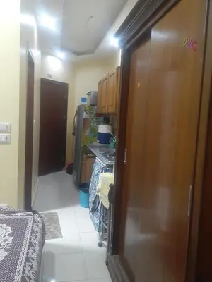 a hallway of a room with a bed and cabinets at Kazpilkna Beach Neighborhoods in Hurghada