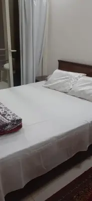 a white bed sitting in a bedroom next to a window at Kazpilkna Beach Neighborhoods in Hurghada